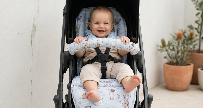 Smiling baby sitting in a stroller with a cushioned stroller liner, showing comfort, support, and secure harness fit.