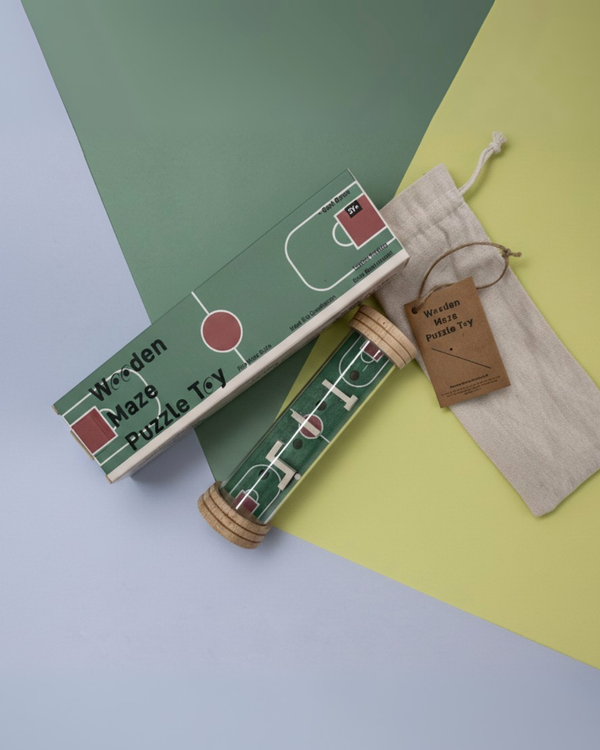 Rolling ball maze toy in green sports field pattern, packed in box and drawstring pouch.