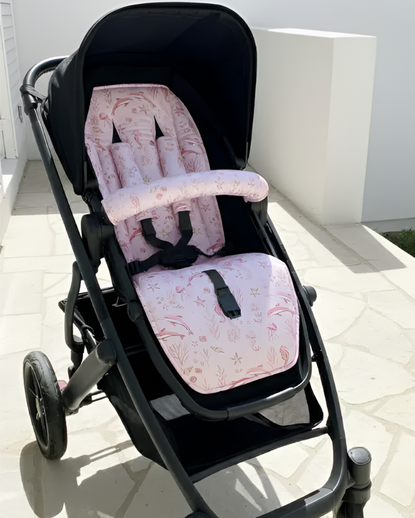 Black stroller with pink floral cushion on a light background