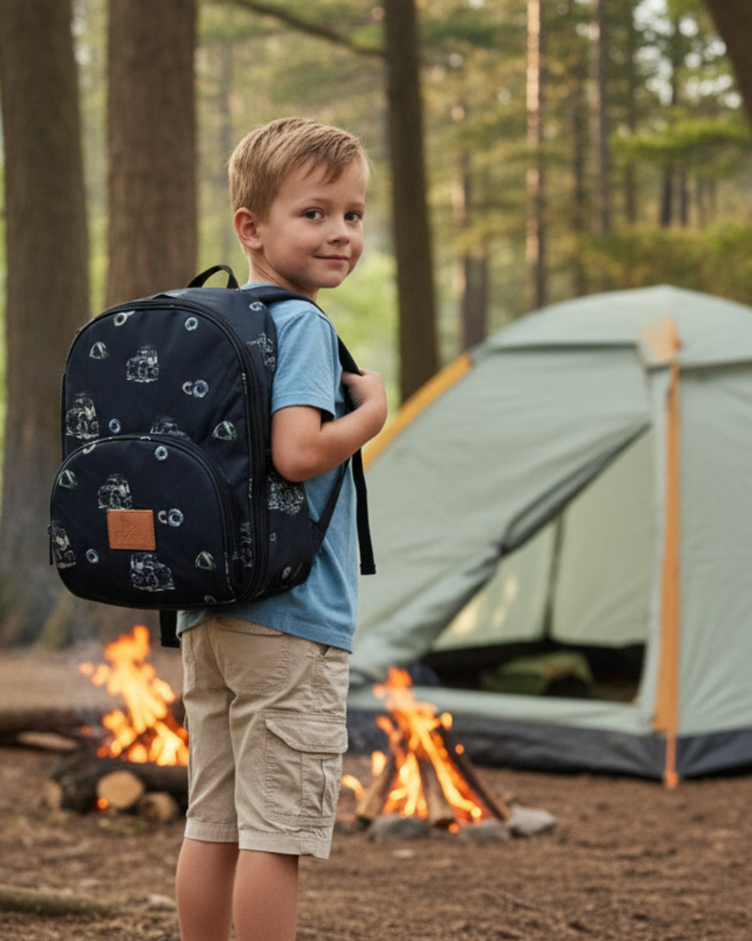 Child with a backpack standing near a campfire and tent in a forest setting