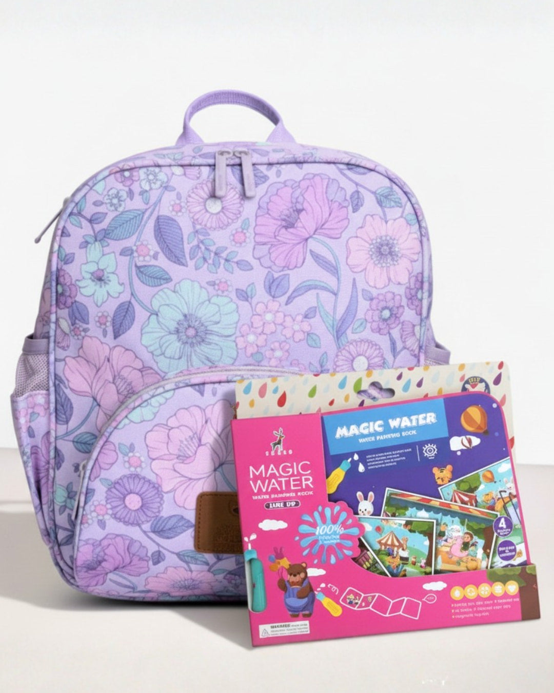 Floral-patterned backpack with a Magic Water educational kit on a white background