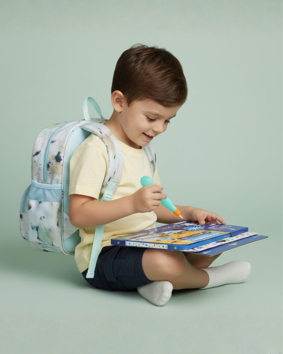 Child with a backpack reading a book on a light green background