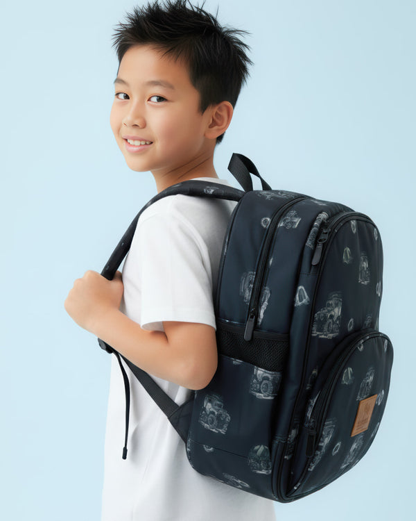 Child wearing a dark blue backpack with a pattern against a light blue background