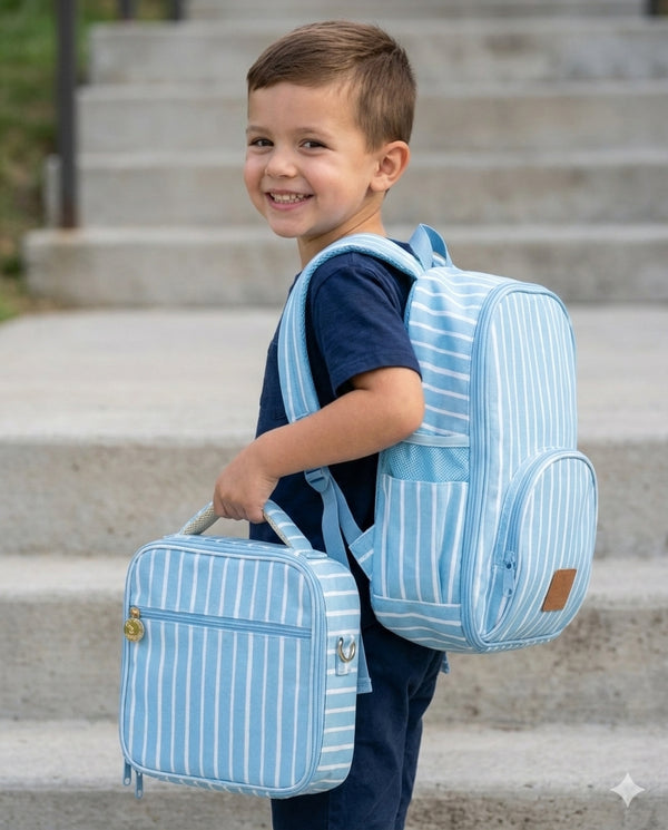 Child wearing a blue striped backpack and suitcase on steps