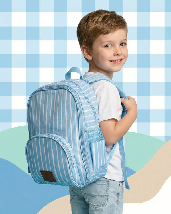 Child wearing a blue striped backpack against a checkered background