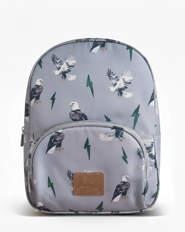 Grey kids backpack featuring an all-over print of eagles and green lightning bolts with a front zip pocket and top handle.