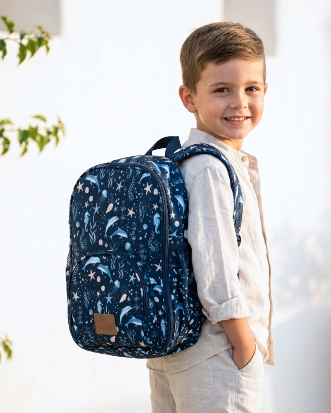 Child wearing a blue patterned backpack outdoors