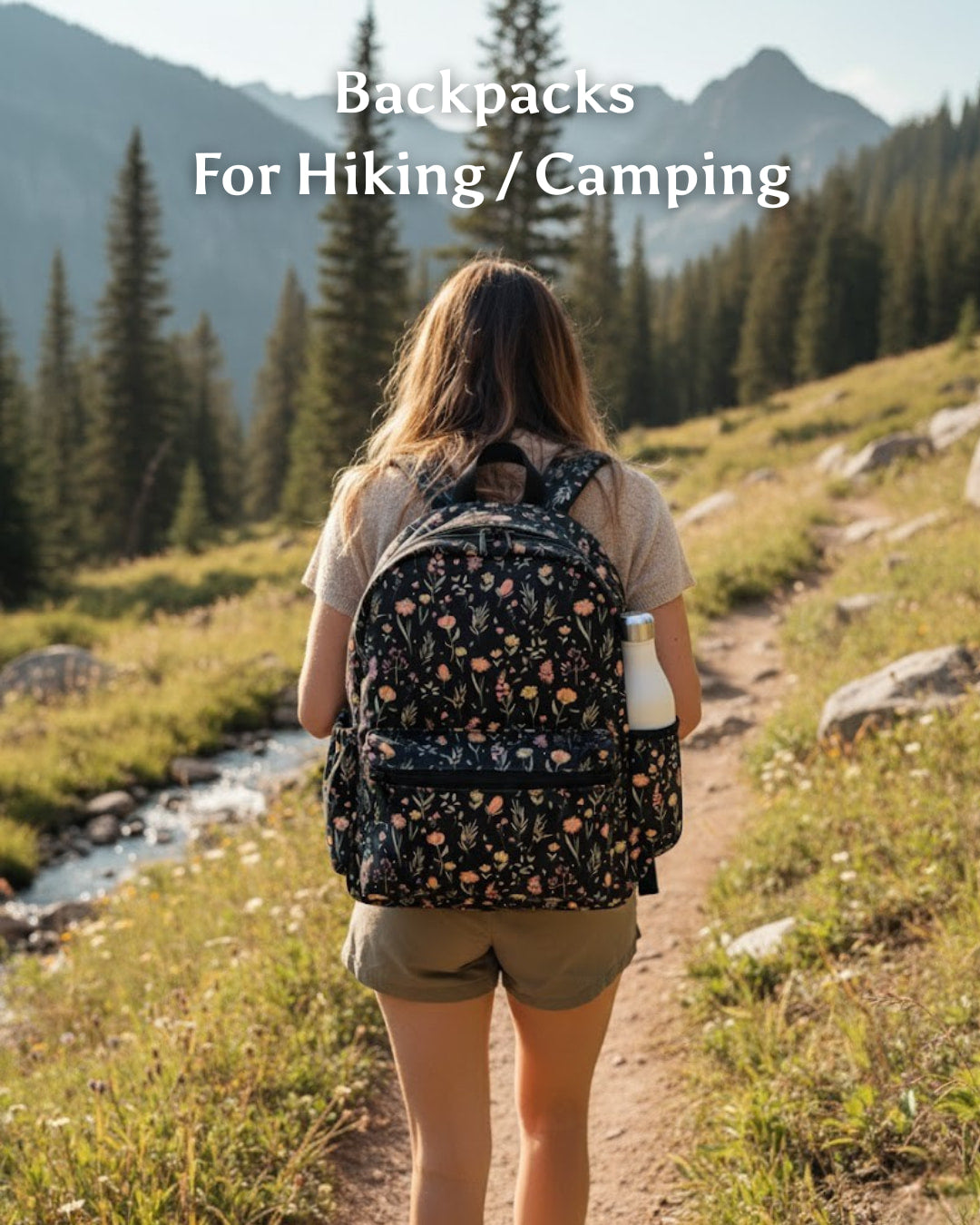 Person with a floral backpack walking on a trail in a mountainous area