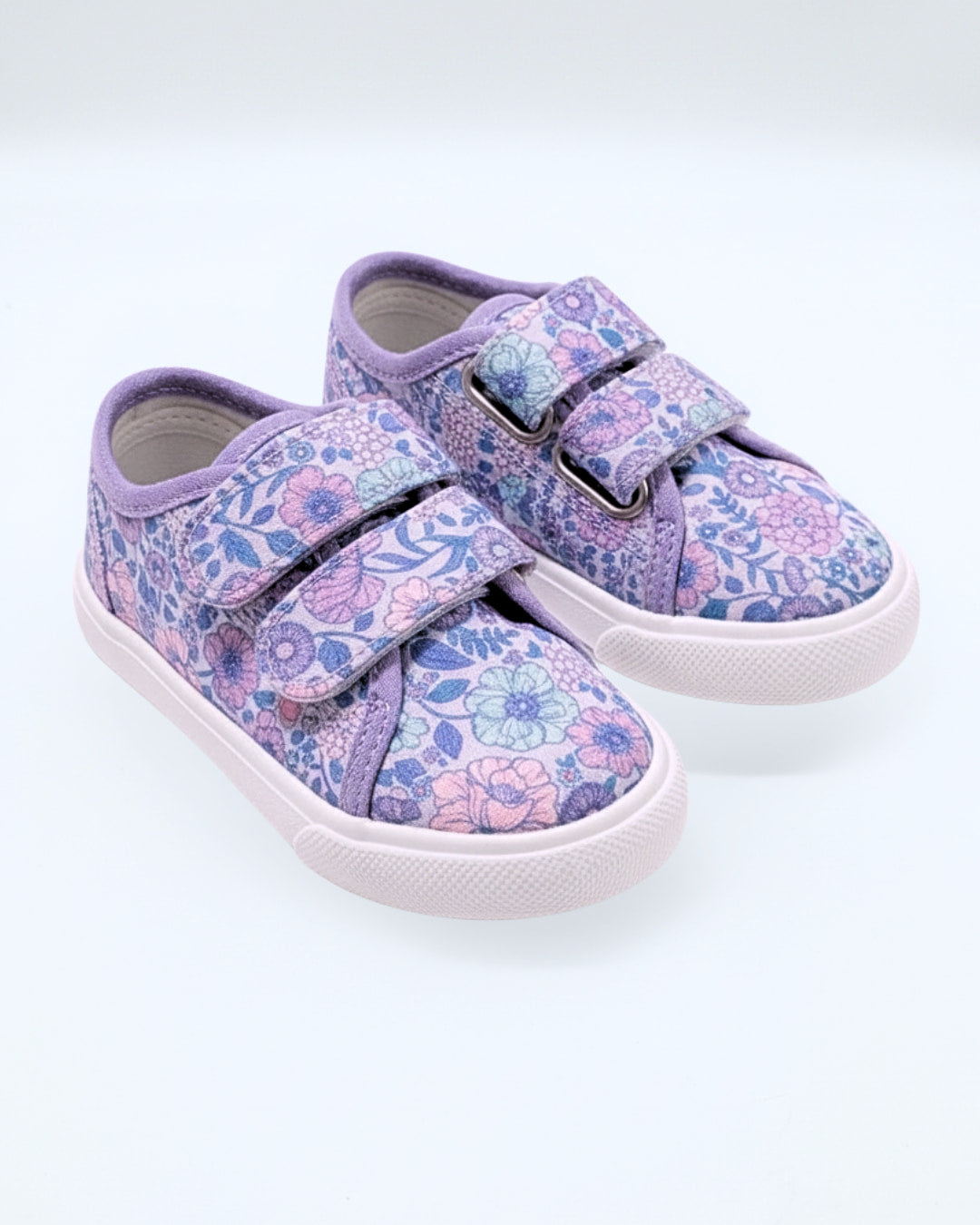 Pair of children's floral sneakers with velcro straps on a white background