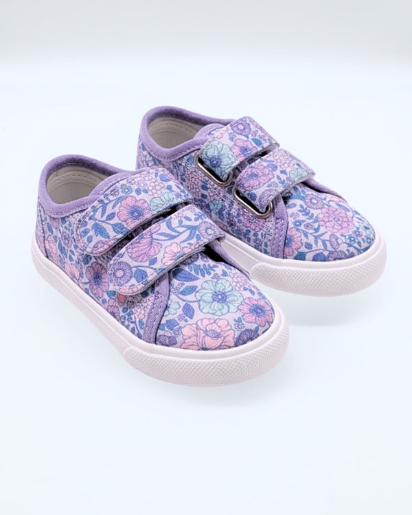 Pair of children's floral sneakers with velcro straps on a white background