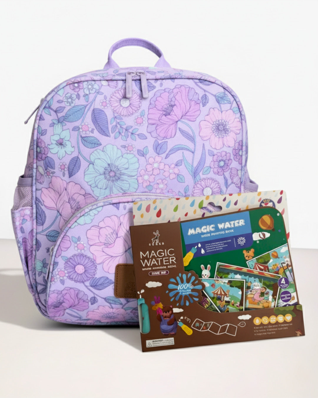 Floral-patterned backpack with a Magic Water book on a white background