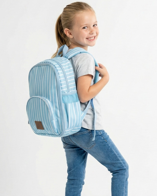 Young girl wearing a blue striped backpack on a white background