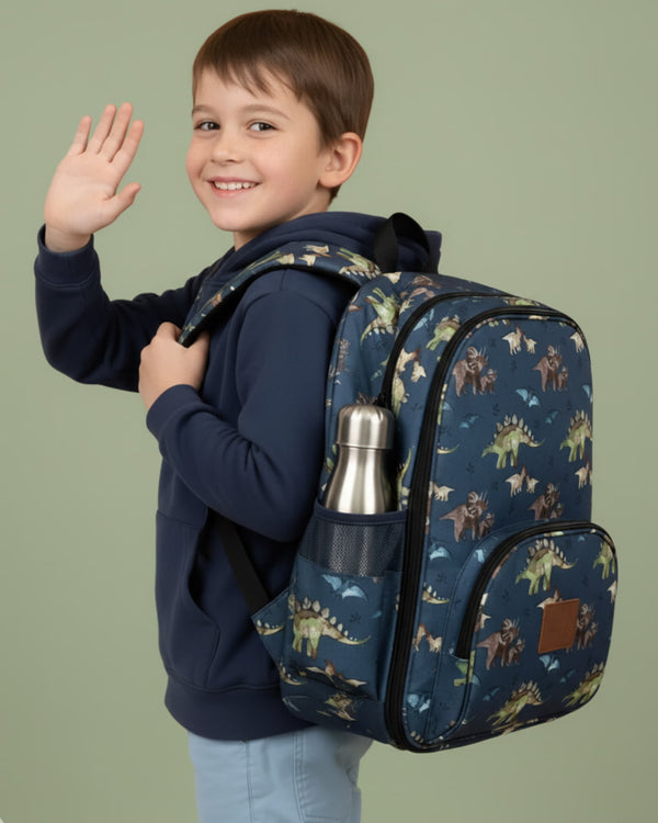 Child wearing a dinosaur-patterned backpack on a plain background