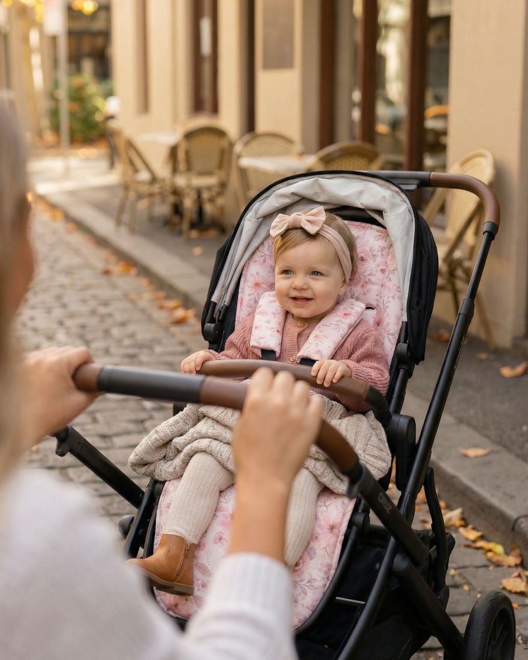 Baby sitting on Amelia universal pram liner pink floral design