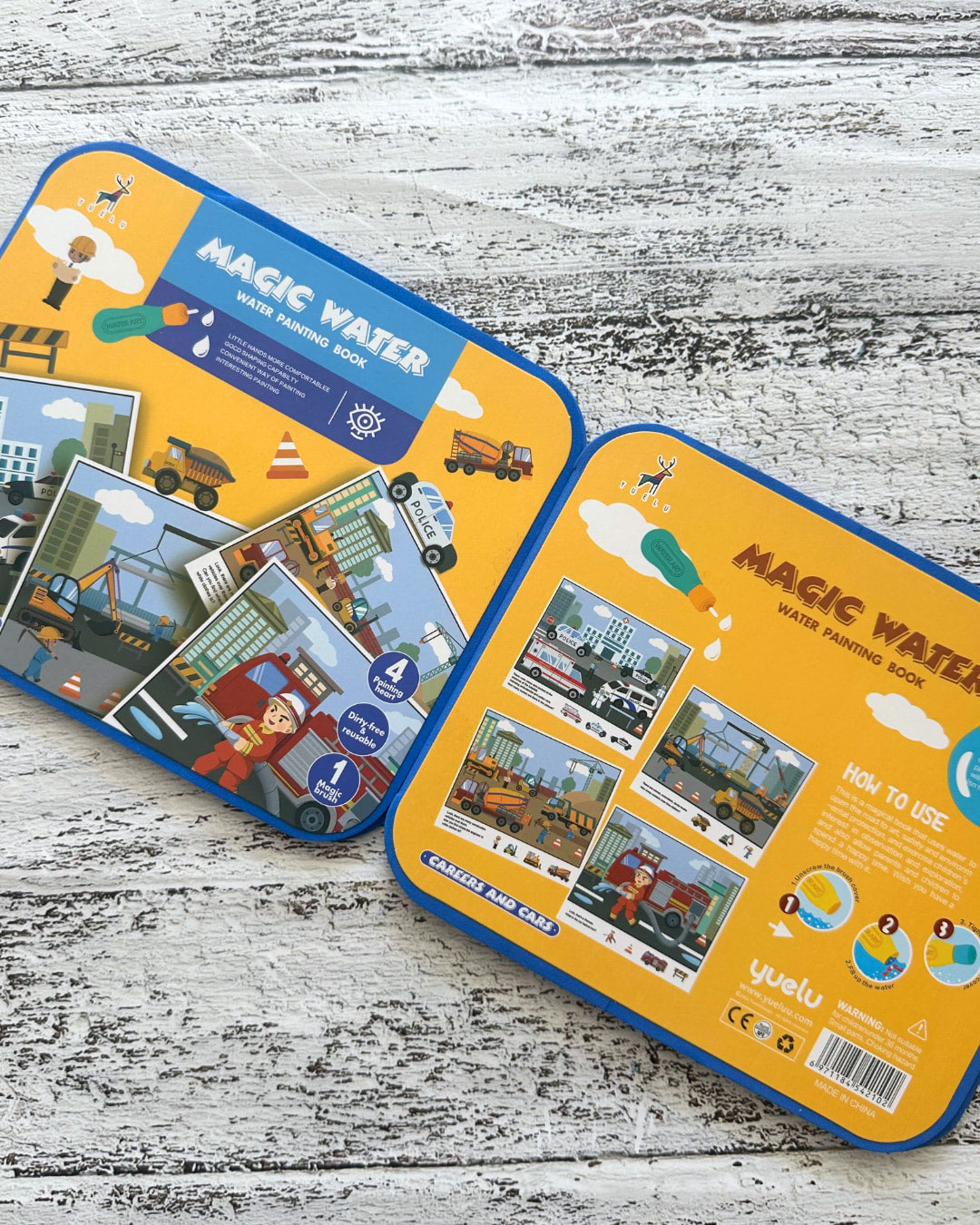 Two 'Magic Water' painting books on a wooden surface