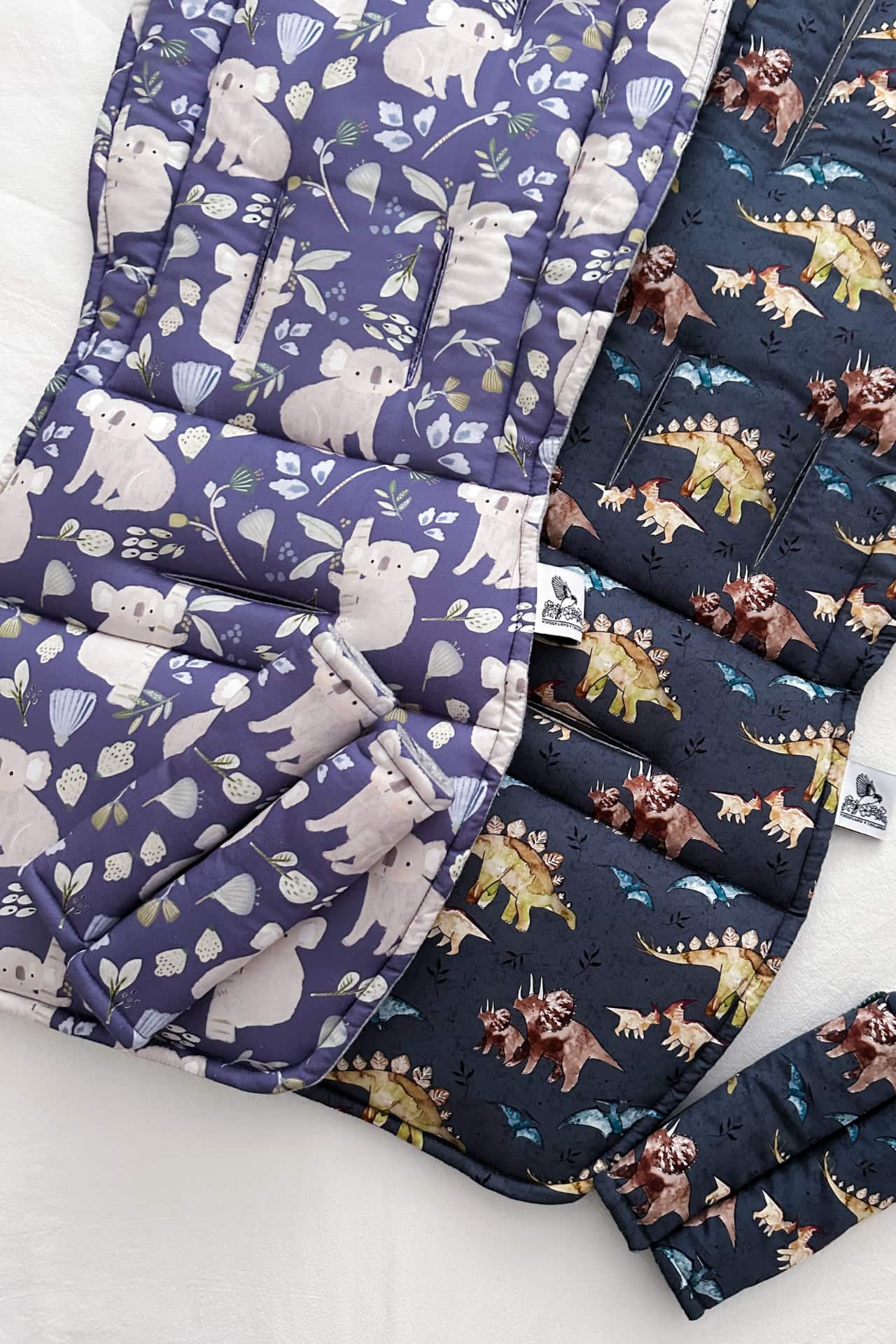 two pram liners with matching shoulder strap covers