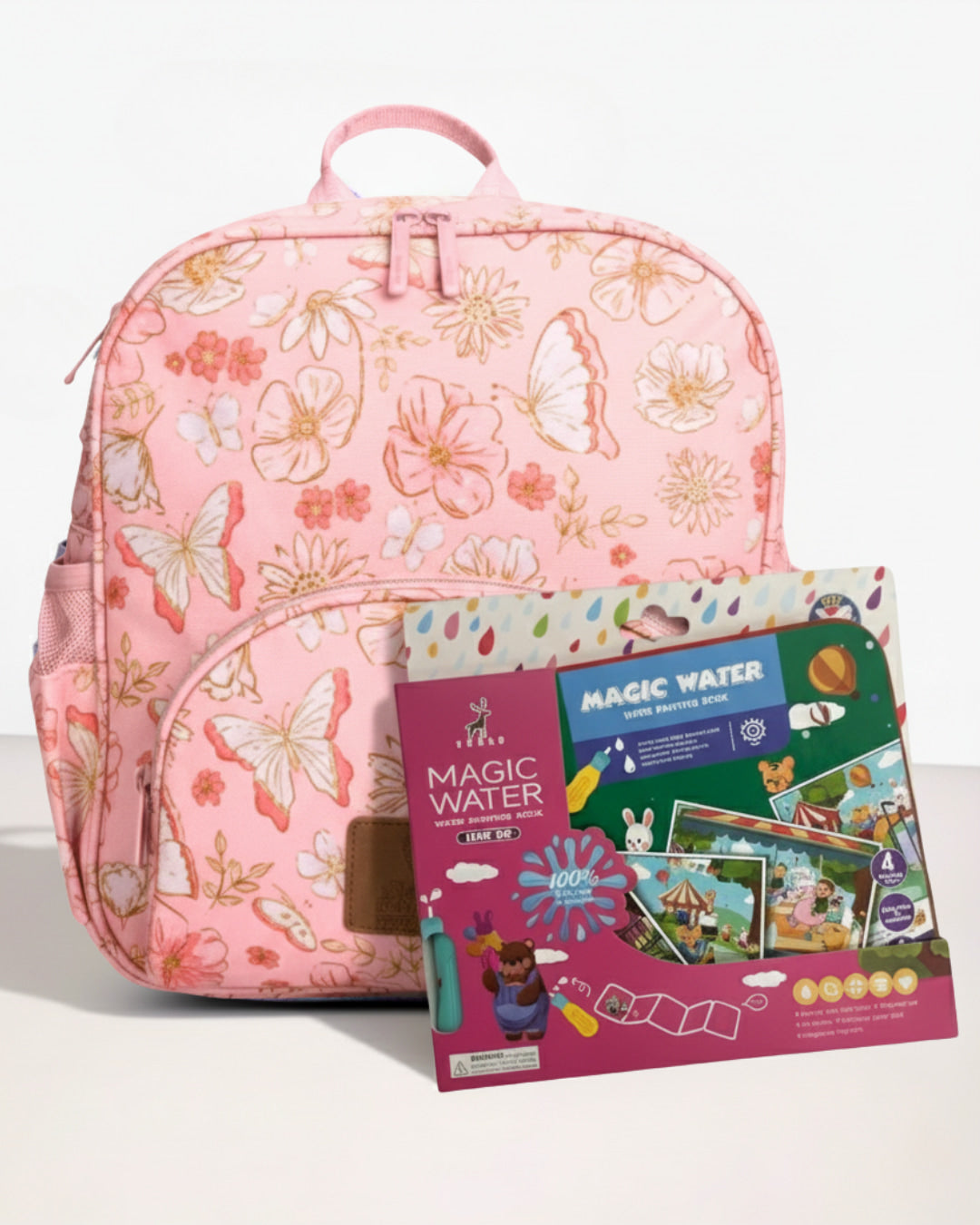 Pink backpack with butterfly design and 'Magic Water' book set on a white background