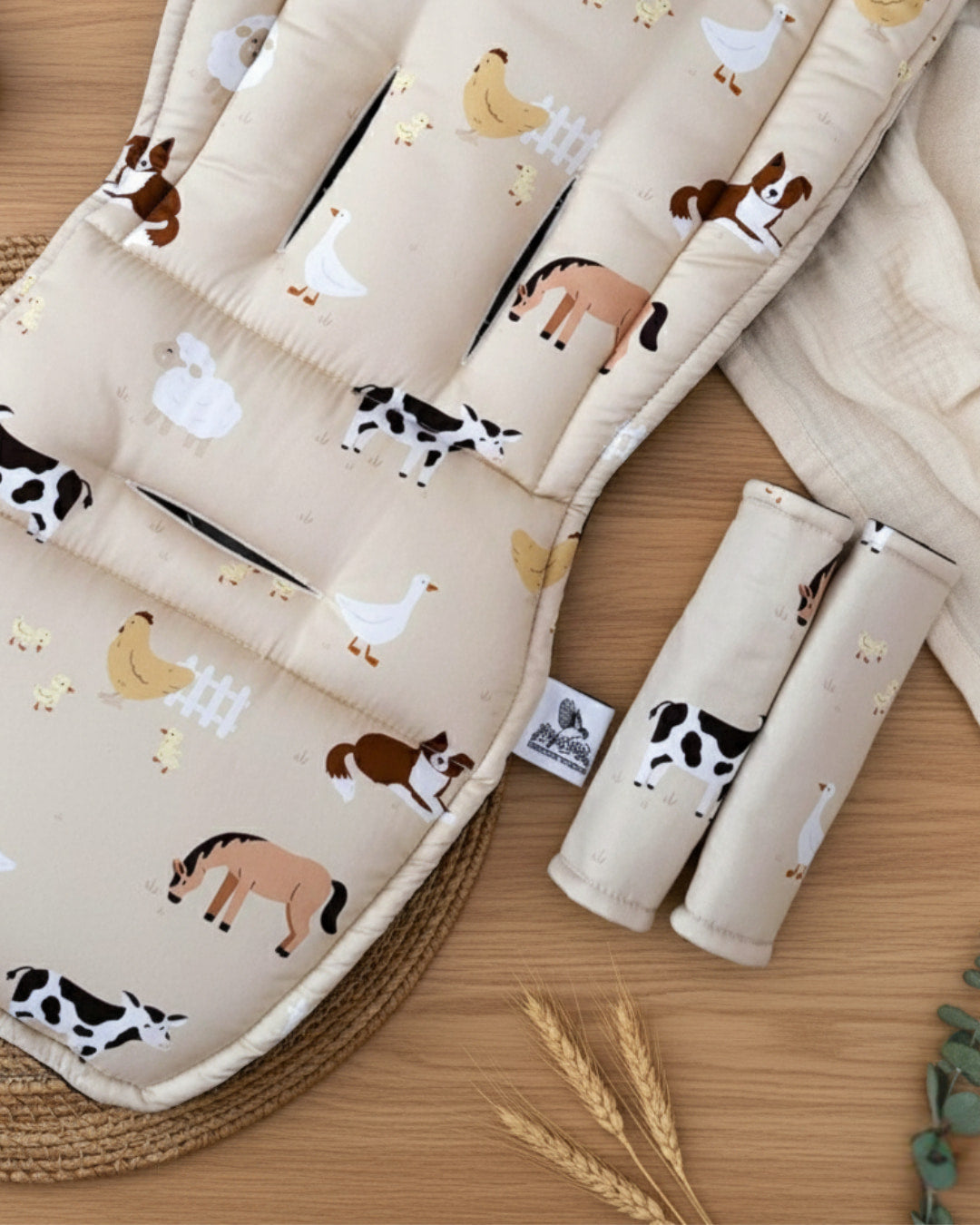 Baby crib sheet with animal patterns on a wooden surface