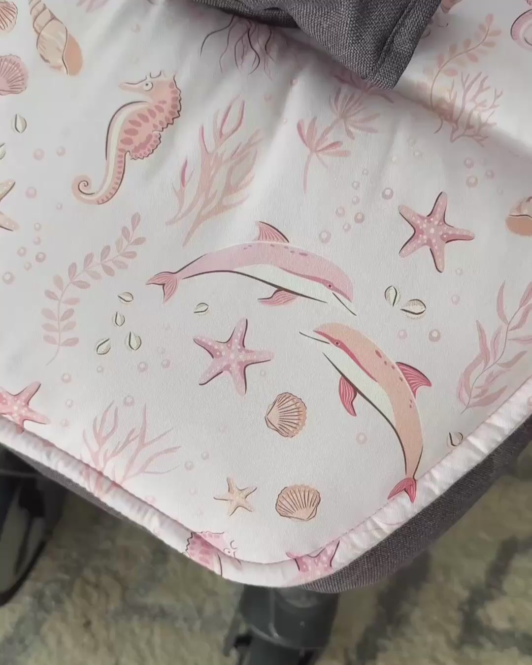 Baby's view showing the matching pink floral shoulder strap covers included with the ALIA universal pram liner for total comfort.