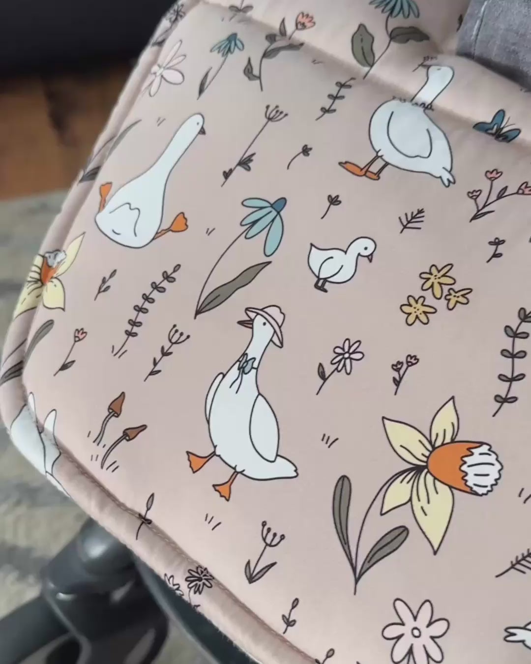 Detailed close-up of the charming goose and wildflower print on a soft cotton universal pram liner, perfect for a stylish and comfortable ride.