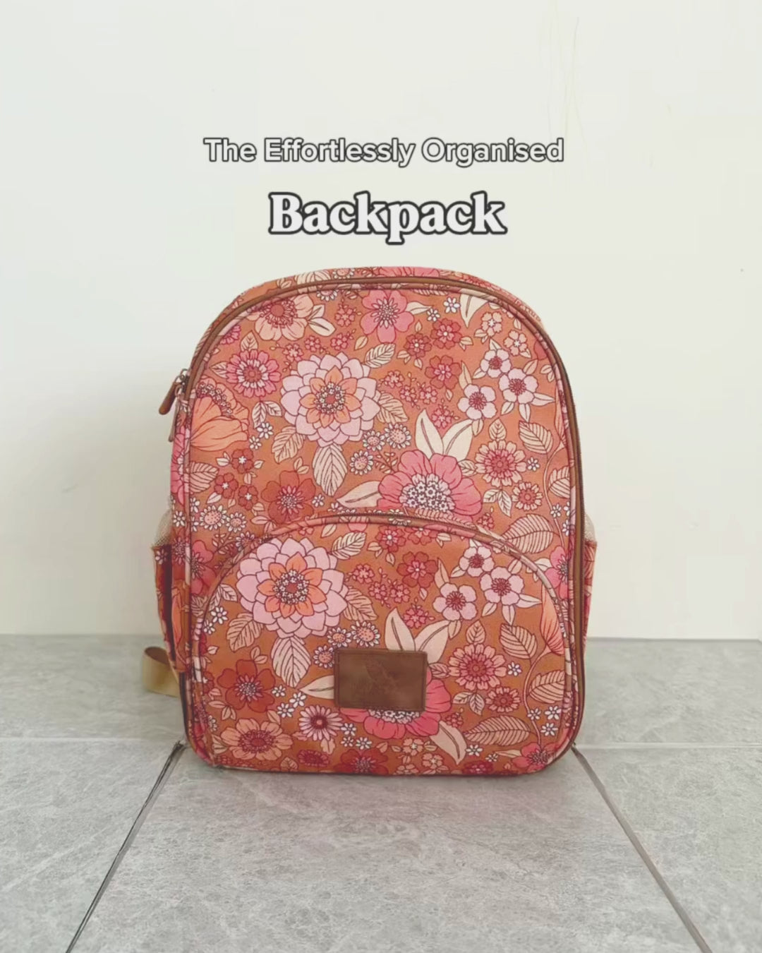 Effortlessly organised small retro floral backpack showing front pocket and durable brown accents for kids or parents.