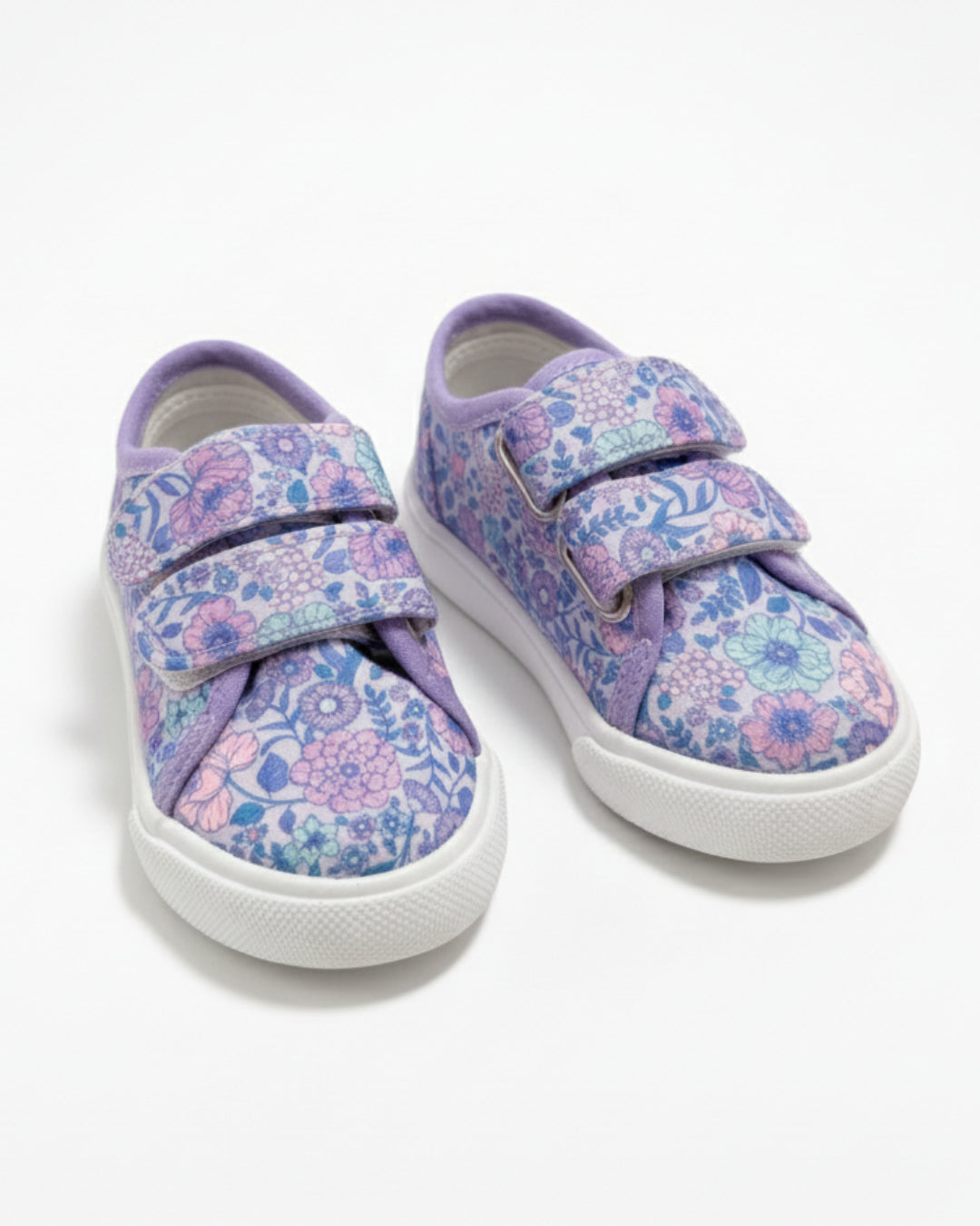 Pair of purple floral sneakers with velcro straps on a white background